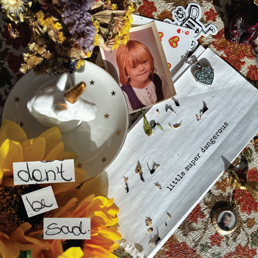 Don't Be Sad album cover — collage of dried flowers, a childhood school photo, lockets, and a handwritten note