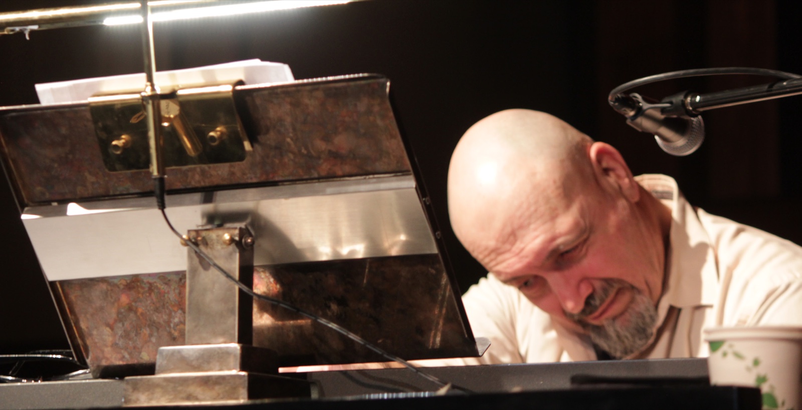 A pianist from the Cracked Pots leaning over the keys of a grand piano during a service at Central United Church.